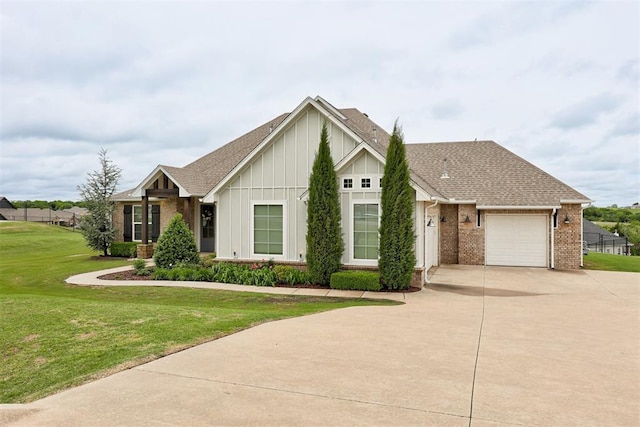 ranch-style home with brick siding, a garage, board and batten siding, a front yard, and concrete driveway