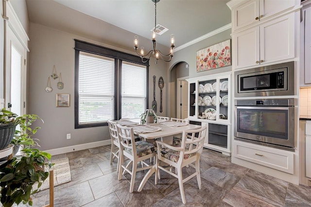 dining room featuring visible vents, baseboards, crown molding, and a wealth of natural light
