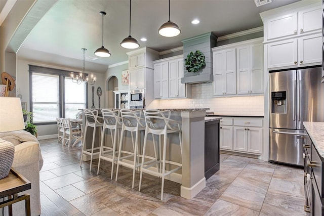 kitchen featuring crown molding, baseboards, recessed lighting, tasteful backsplash, and stainless steel appliances