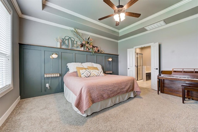 bedroom with visible vents, crown molding, a raised ceiling, and carpet floors