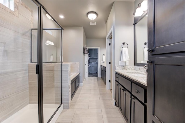 full bath featuring vanity, tile patterned flooring, a stall shower, and visible vents