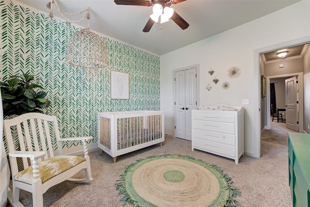 carpeted bedroom with baseboards, ornamental molding, a ceiling fan, and wallpapered walls