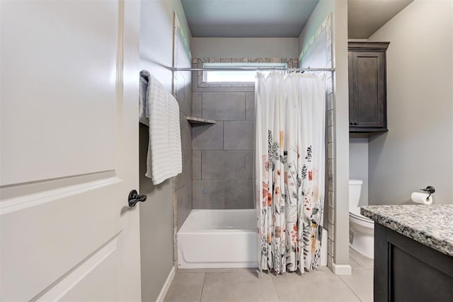bathroom featuring tile patterned flooring, shower / bath combo, vanity, baseboards, and toilet