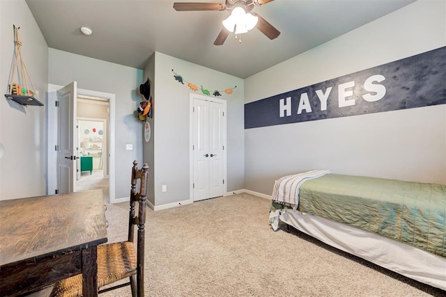 carpeted bedroom featuring baseboards, a ceiling fan, and a closet