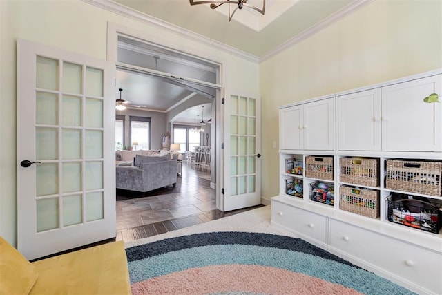 mudroom with french doors, arched walkways, baseboards, an inviting chandelier, and ornamental molding