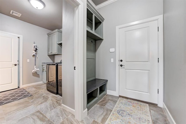 mudroom featuring visible vents, baseboards, marble finish floor, washer / dryer, and ornamental molding
