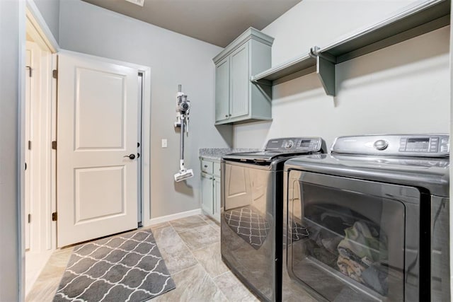 laundry area with cabinet space and separate washer and dryer