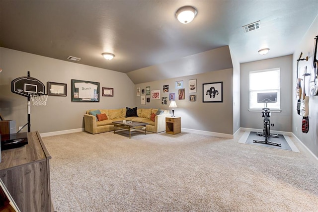 carpeted living area featuring visible vents and baseboards