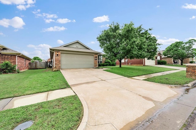 ranch-style house featuring brick siding, driveway, fence, and a front yard
