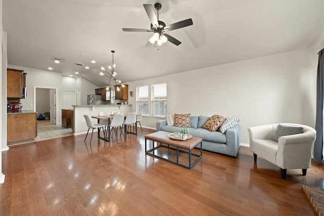 living room featuring visible vents, a ceiling fan, recessed lighting, wood finished floors, and vaulted ceiling