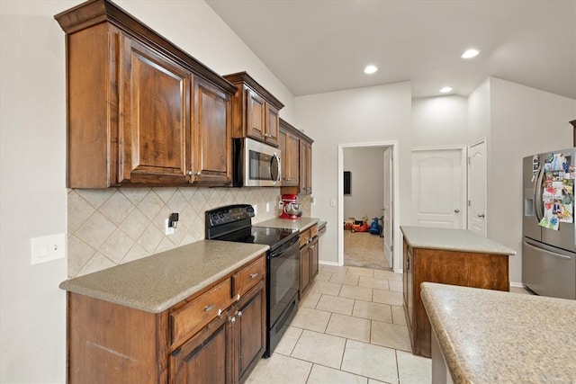 kitchen with backsplash, light tile patterned floors, baseboards, stainless steel appliances, and recessed lighting