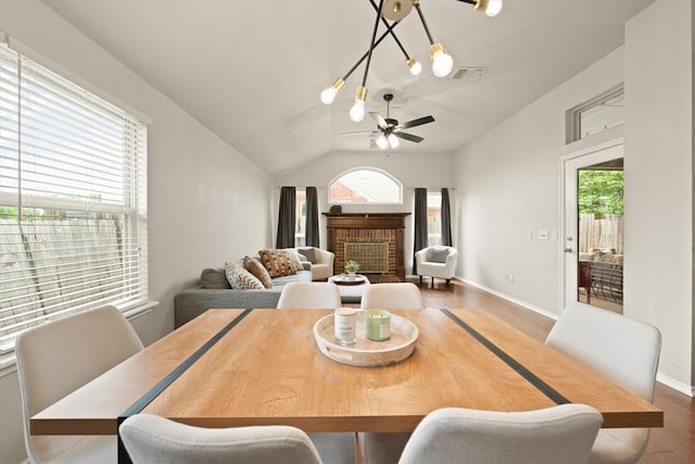 dining space featuring a ceiling fan, lofted ceiling, wood finished floors, and a wealth of natural light