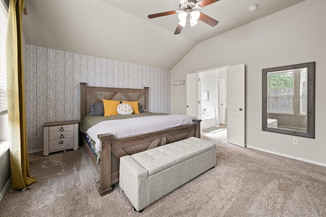 carpeted bedroom featuring a ceiling fan, baseboards, connected bathroom, lofted ceiling, and wallpapered walls