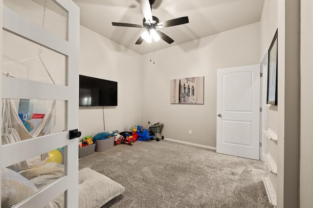recreation room with carpet floors, baseboards, and ceiling fan