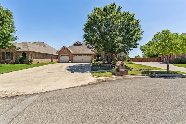 view of front of house with brick siding, fence, an attached garage, concrete driveway, and a front lawn