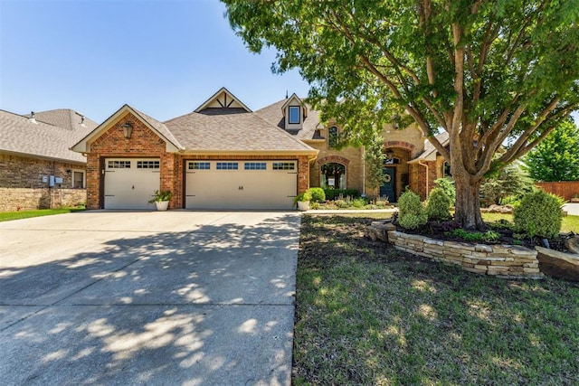 view of front of property with concrete driveway, a shingled roof, brick siding, and a garage