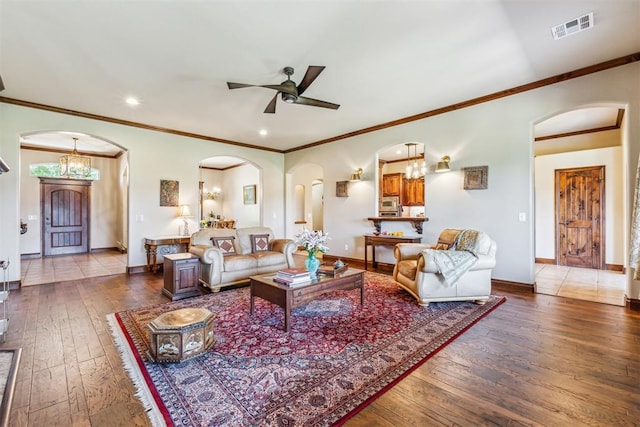 living room with ceiling fan, arched walkways, and hardwood / wood-style flooring