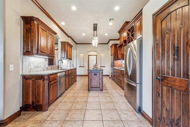 kitchen with recessed lighting, visible vents, a sink, arched walkways, and stainless steel appliances