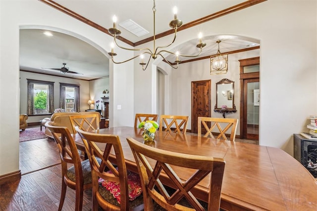 dining room with a ceiling fan, ornamental molding, visible vents, hardwood / wood-style flooring, and arched walkways