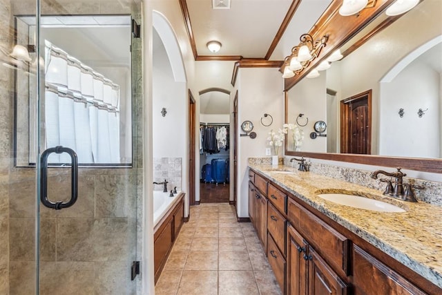 full bathroom featuring a sink, crown molding, and a shower stall