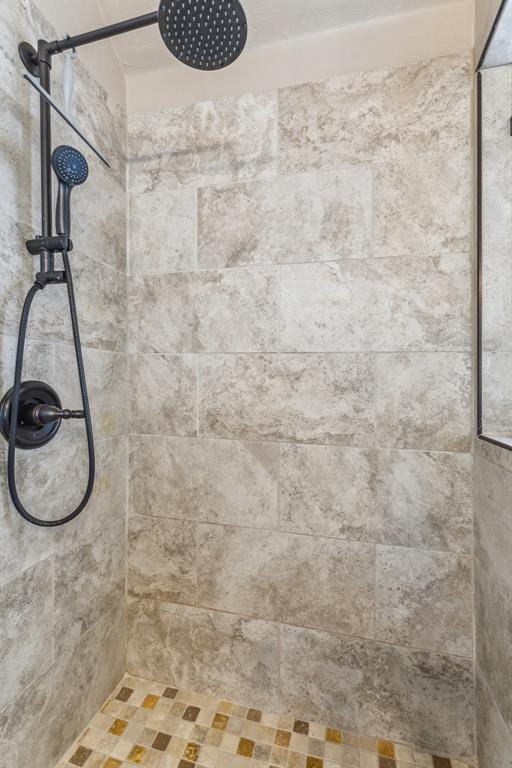 interior details featuring a tile shower