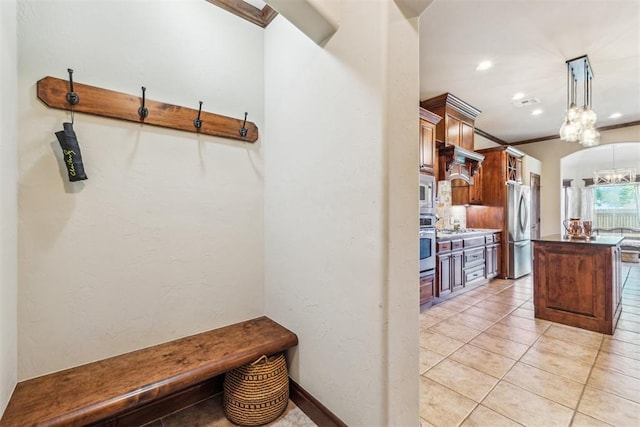 mudroom with a chandelier, light tile patterned flooring, and recessed lighting