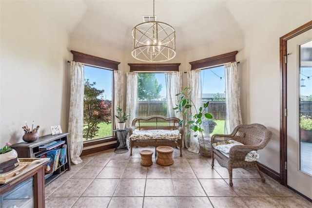 interior space with a healthy amount of sunlight, a chandelier, and visible vents