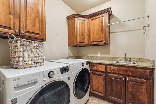 clothes washing area featuring cabinet space, washer and clothes dryer, and a sink