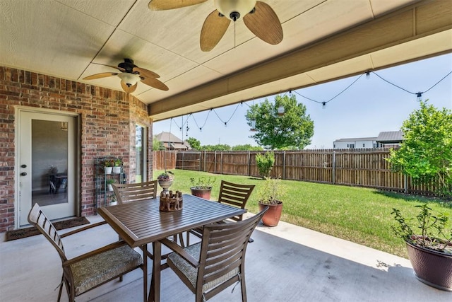 view of patio featuring a fenced backyard, a ceiling fan, and outdoor dining space