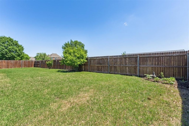 view of yard with a fenced backyard