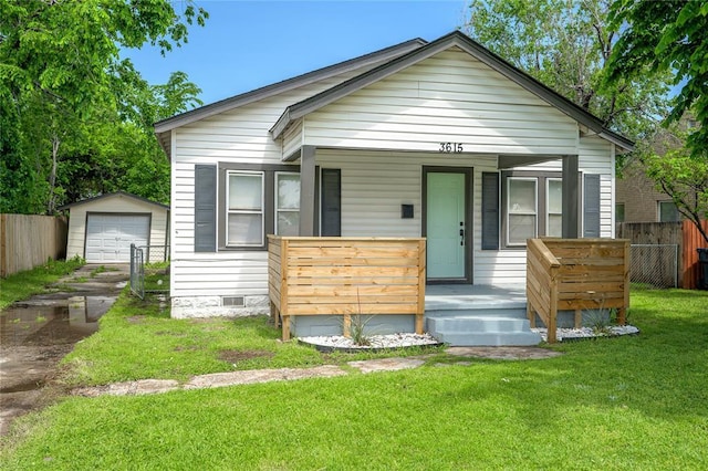 bungalow-style house with fence, a front lawn, a porch, crawl space, and an outdoor structure