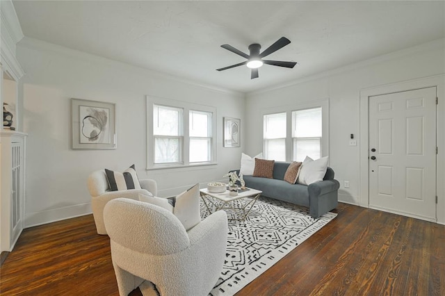 living room featuring ceiling fan, ornamental molding, baseboards, and dark wood-type flooring