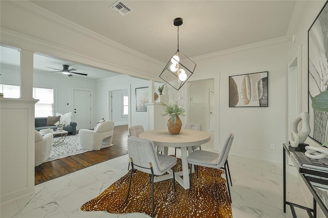 dining space featuring crown molding, baseboards, visible vents, and marble finish floor