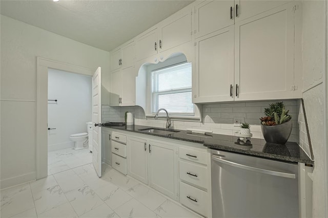 kitchen with a sink, marble finish floor, dishwasher, and white cabinets