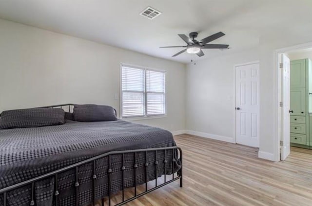 bedroom featuring baseboards, a ceiling fan, light wood-type flooring, and visible vents
