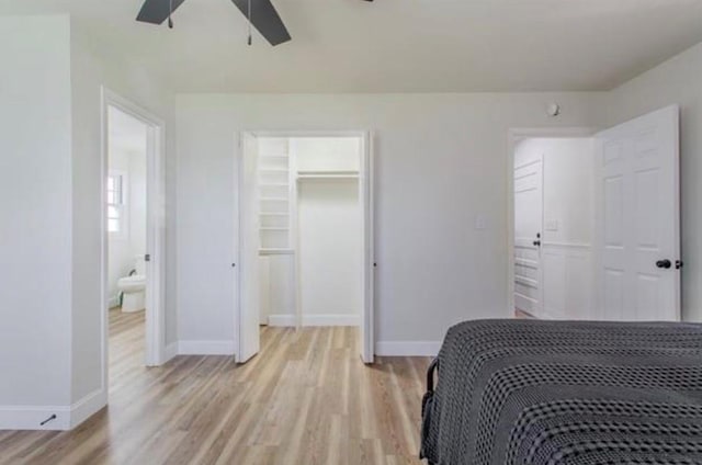 bedroom featuring a closet, light wood finished floors, and baseboards