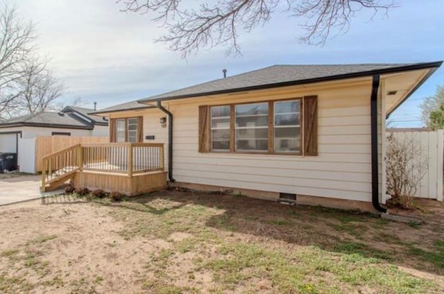 back of house featuring a deck and fence