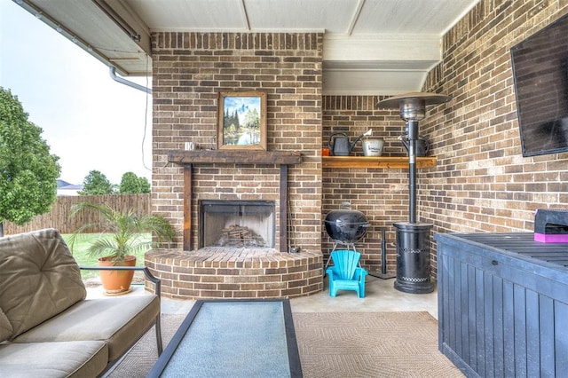 view of patio / terrace with fence and an outdoor brick fireplace