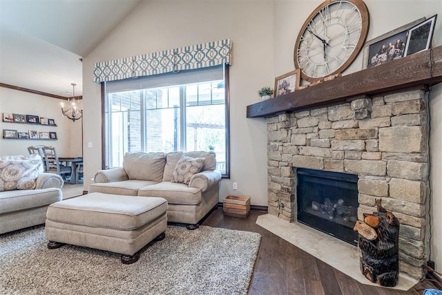 living room with wood-type flooring, a chandelier, a stone fireplace, and a healthy amount of sunlight