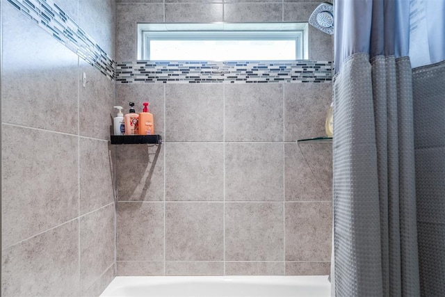 bathroom with shower / bath combo with shower curtain
