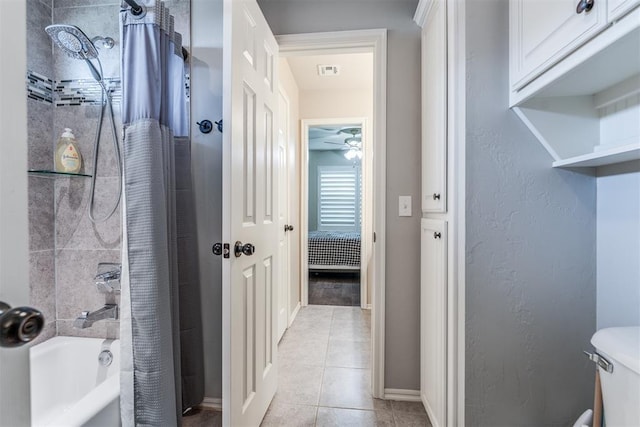 full bath featuring toilet, tile patterned floors, a ceiling fan, baseboards, and visible vents