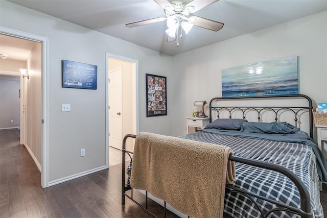 bedroom with baseboards, a ceiling fan, and dark wood finished floors