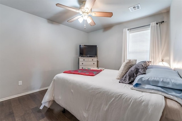 bedroom featuring dark wood finished floors, a ceiling fan, baseboards, lofted ceiling, and visible vents