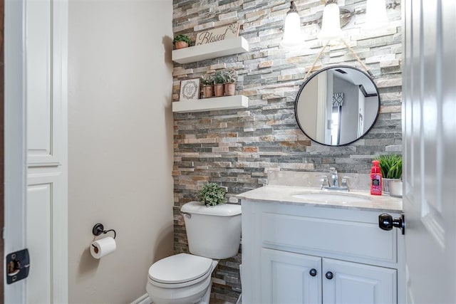 bathroom featuring toilet and vanity