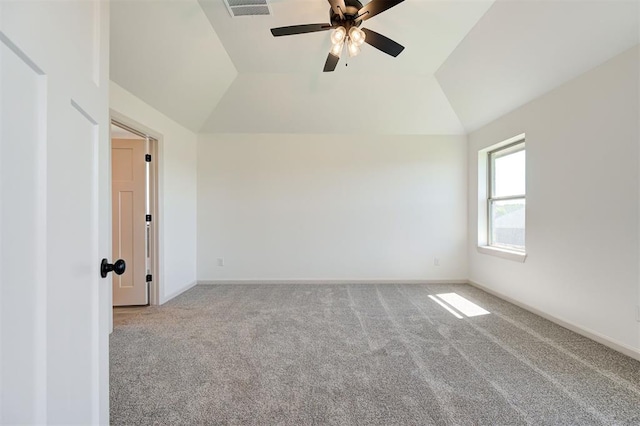 carpeted empty room with baseboards, a ceiling fan, lofted ceiling, and visible vents