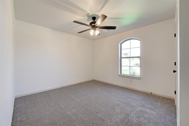 unfurnished room featuring baseboards, ceiling fan, and light carpet