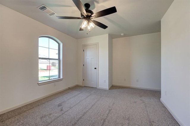 unfurnished bedroom featuring visible vents, baseboards, light carpet, and multiple windows