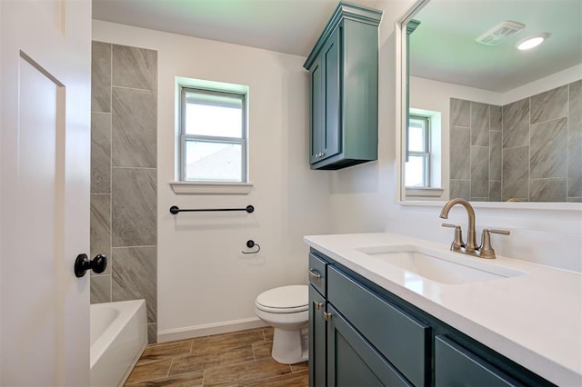 full bathroom with a healthy amount of sunlight, vanity, toilet, and visible vents
