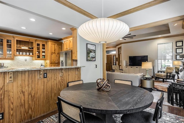 dining area featuring crown molding, wood finished floors, ceiling fan, recessed lighting, and bar