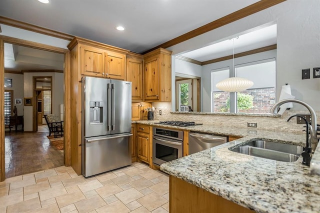 kitchen featuring crown molding, light stone countertops, a sink, backsplash, and stainless steel appliances